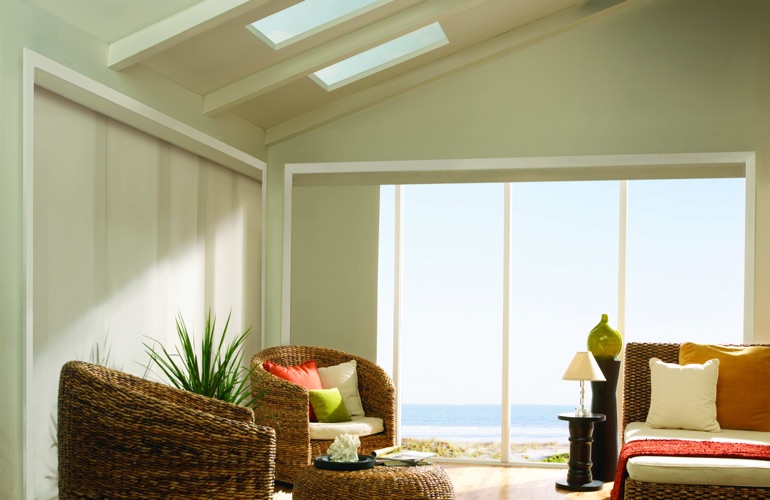 Sunroom with wicker chairs overlooking water with UV window film